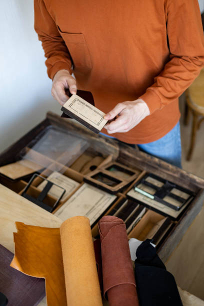 istock Top view craftsman hands choosing curly knife or punching for cutting shape work with natural stuff 1355174817
