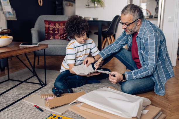 istock Father and son following DIY instructions at home 1355174828