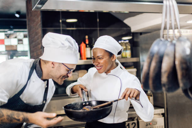 istock Chef is guiding a new employee how to work at his kitchen 1355175996