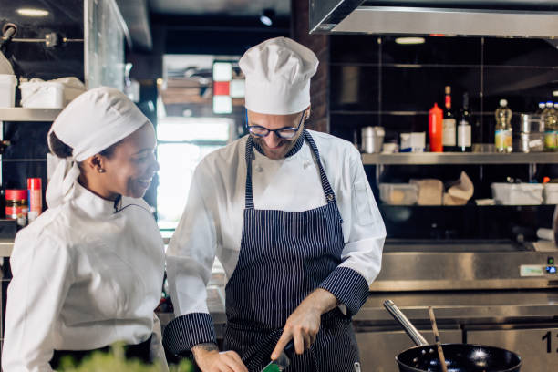 istock Happy cook learning to cook from the chef 1355175999