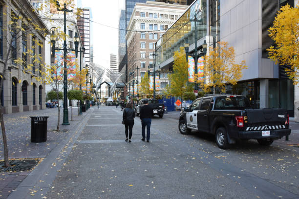 Stephen Avenue In Calgary Alberta Canada, Police Land Vehicle, People Walking Stephen Avenue In Calgary Alberta Canada, Retail Store, Building Exterior, Restaurant, Advertisement Sign, People Wearing Face Mask Due To COVID-19 Pandemic, Walking, Police Land Vehicle, Sky Scene During Autumn Season police station canada stock pictures, royalty-free photos & images
