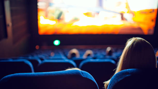Movie theater during the screening of an animated movie Movie theater during the screening of an animated movie. spectator stock pictures, royalty-free photos & images