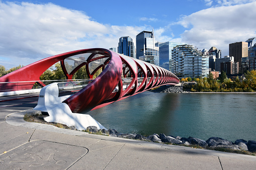 Peace Bridge, Building Exterior, Sky, Bow River, Tree, People Scene During Autumn Season In Calgary Alberta Canada