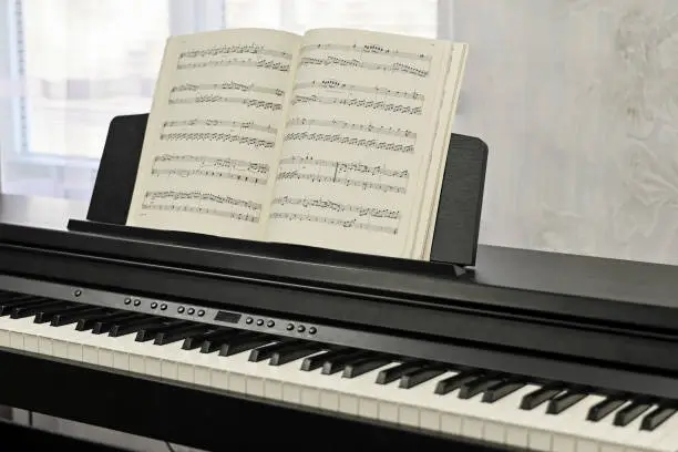 Photo of Piano keys, sheet music. electronic piano at a music school