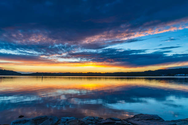istock Sunrise waterscape over the bay with cloud cover 1355183853
