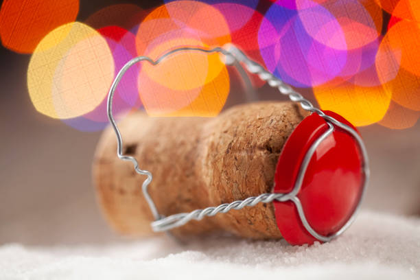 Champagne cork on a wooden table in front Christmas tree