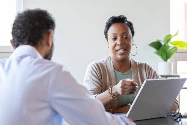istock Consultant Meeting With Client in boardroom 1355188790