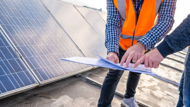 istock Technicians studying electrical diagrams of solar park 1355188870