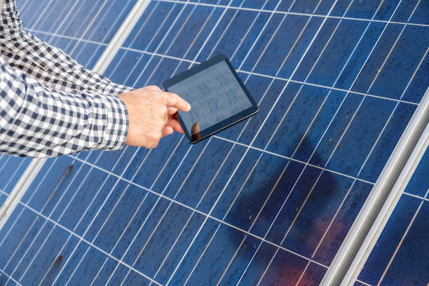 istock Male hands, wireless device and photovoltaic panels 1355188885