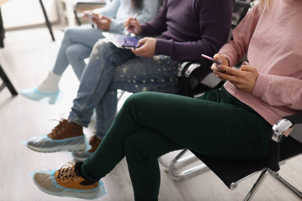 People sitting in line and surfing gadgets