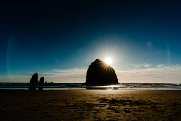 istock Moody image of haystack rock just before sunset 1355191752