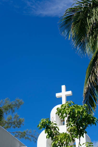 istock White cross church against blue sky 1355191754