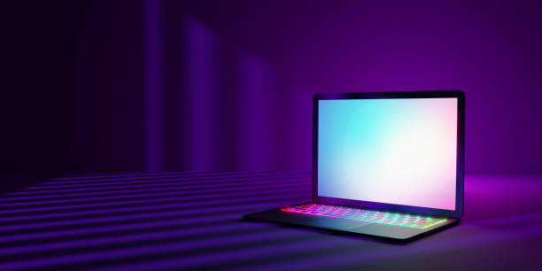 istock 3D rendering illustration. Laptop computer with blank screen and colorful keyboard place in the darkroom and purple lighting shadow. Image for presentation. 1355196338