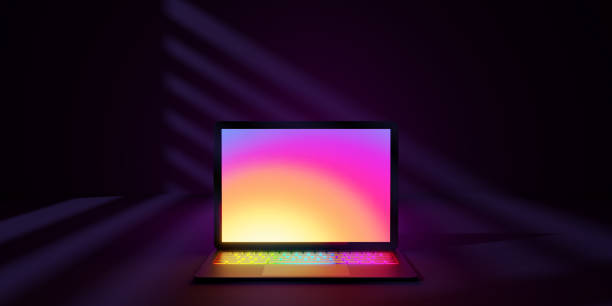 istock 3D rendering illustration. Laptop computer with colorful screen and keyboard place in the darkroom and purple lighting. Image for presentation. 1355196339