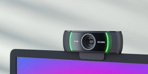 istock 3D rendering object. Close up of web camera placed on laptop screen and blue wall with sun light. 1355196396