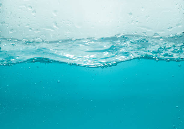istock Water waves splash with air bubbles, isolated on the white background. abstract blue water waves on a white background. for a product, advertising,text space 1355199225