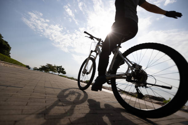 istock Riding bike without holding the handlebar on the sunrise coast path 1355201342