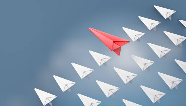 istock 3d red paper plane with white paper plane row on blue sky background. 3D illustration rendering. 1355201486