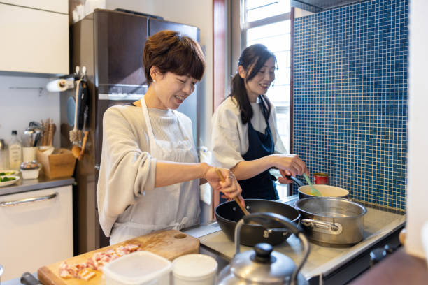 istock Female friends cooking at home for lunch 1355203541