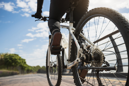 Woman riding bike at city on sunny day