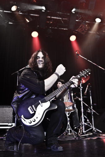 Rock guitarist performing on stage - Ozzy lookalike