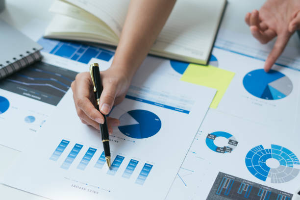 istock Businessman hand checking at diagram on financial report. 1355206108