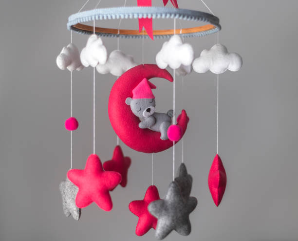 Baby cot mobile, musical toy hang over the crib. Dreamy bear in the moon, space-themed baby cot mobile. Baby cot mobile, musical toy hang over the crib. Dreamy bear in the moon, space-themed baby cot mobile. hanging mobile stock pictures, royalty-free photos & images