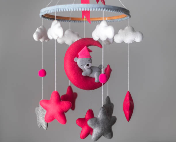 baby cot mobile, musical toy hang over the crib. dreamy bear in the moon, space-themed baby cot mobile. - using mobile imagens e fotografias de stock