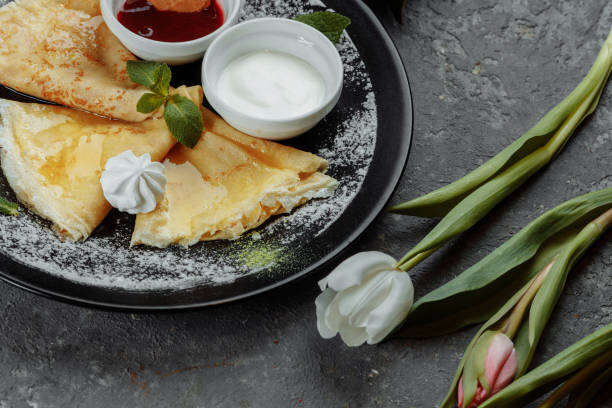 istock Pancakes with strawberries and creme black plate 1355209053