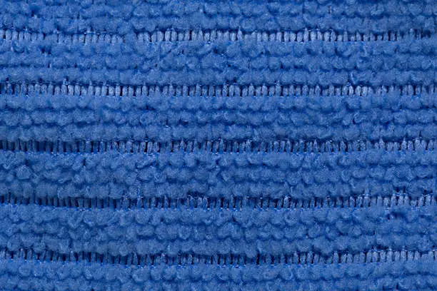 Photo of Fabric blue striped background. Soft fiber texture of interlaced polyester. fine grain fabric.