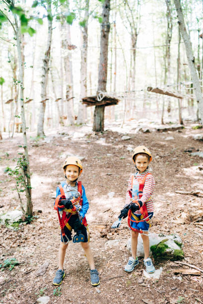 istock Boys are standing on the ground in an adventure park 1355210762