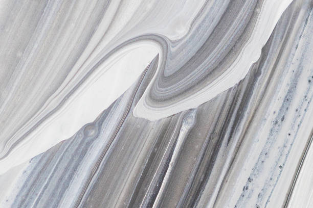 istock Abstract white and black pattern backdrop. Mixing of industrial grey paint close up, stains and streaks 1355211511