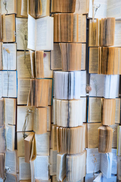 istock backgrounds: many open books. Dried flowers inside. Art object 1355212755