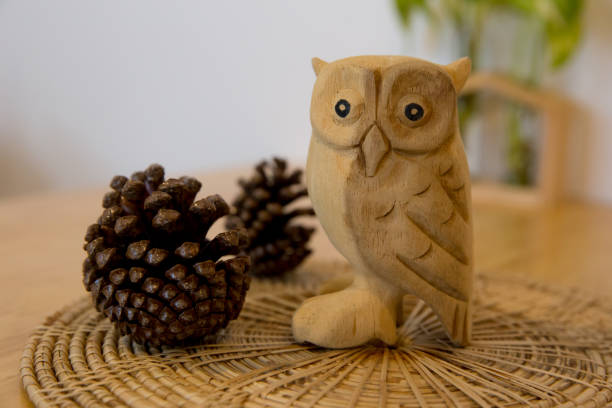 istock Owl doll wood with pine cones focus selective 1355213712