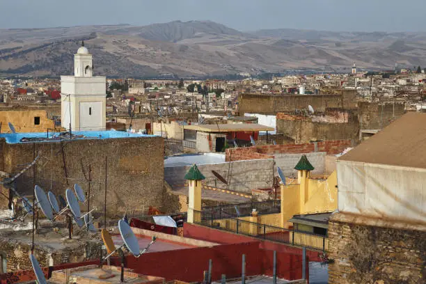 Photo of View of the old buildings roofs in medina quarter of Fez in Morocco. The medina of Fez is listed as a World Heritage Site and is believed to be one of the world largest urban pedestrian zones.