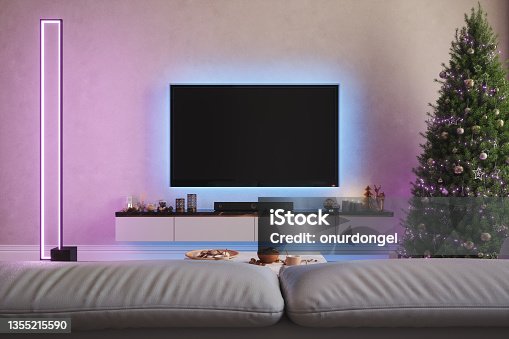 istock Modern Living Room With Television Set, Christmas Tree And Ornaments At Night With Neon Lights 1355215590