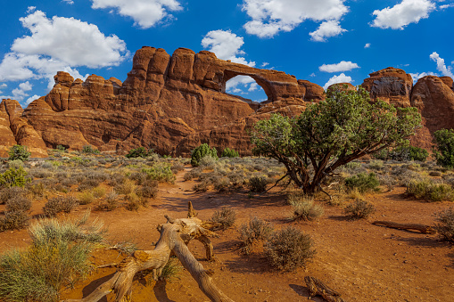 Aerial view looking at a natural arch in Arches National Park, Utah, USA.