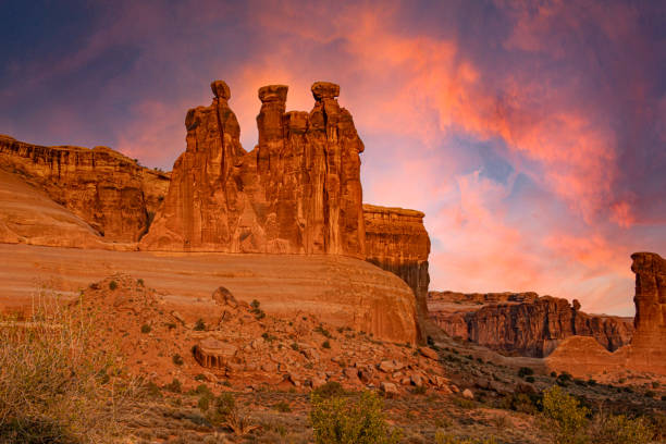 Sunrise at The Three Gossips of Arches The Three Gossips at sunrise in Arches National Park arches national park stock pictures, royalty-free photos & images