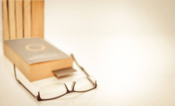 istock read glasses selective focus on blur Bookmark in old book on white background copy space 1355216555