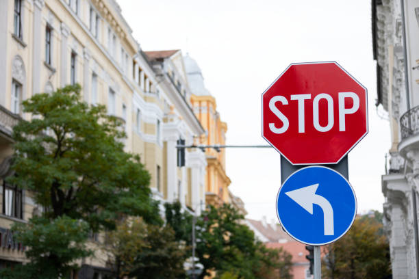 Close up picture of traffic signs in the city - stop and mandatory to the left