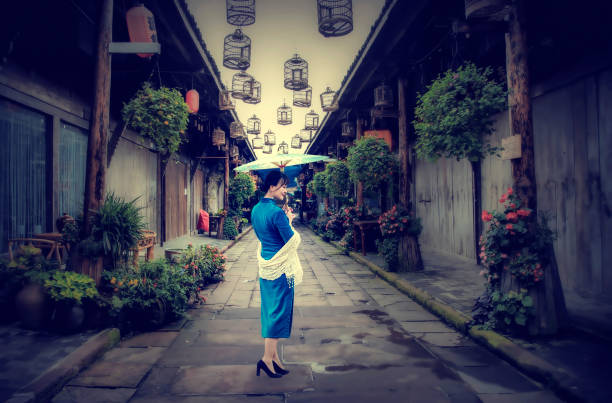 A woman in a cheongsam walks down an ancient street with an umbrella in her hand, retro color card style