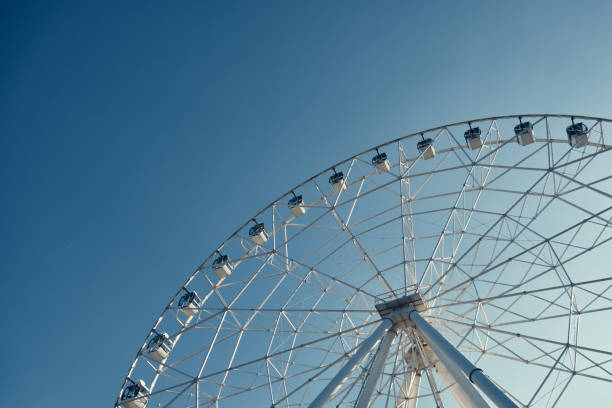 istock Ferris wheel against blue sky 1355224542