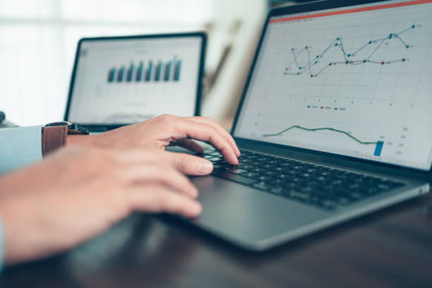 istock Business man working, typing on laptop at office  with document report, graph, financial report. 1355227016