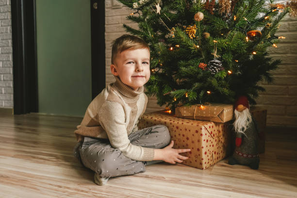 istock Happy little boy and Christmas tree, natural decor. 1355228168