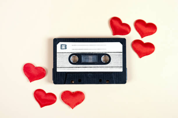 Old Audio Cassette Old Audio Cassette with a Red Hearts on the Paper Background closeup mix tape heart stock pictures, royalty-free photos & images