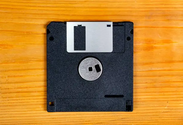 Floppy Disk Drive on a Wooden Plank Background closeup