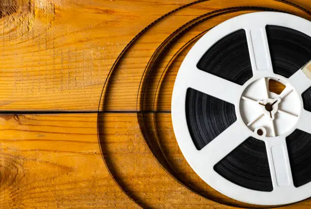 Old Film Reel on the Wooden Planks Background closeup