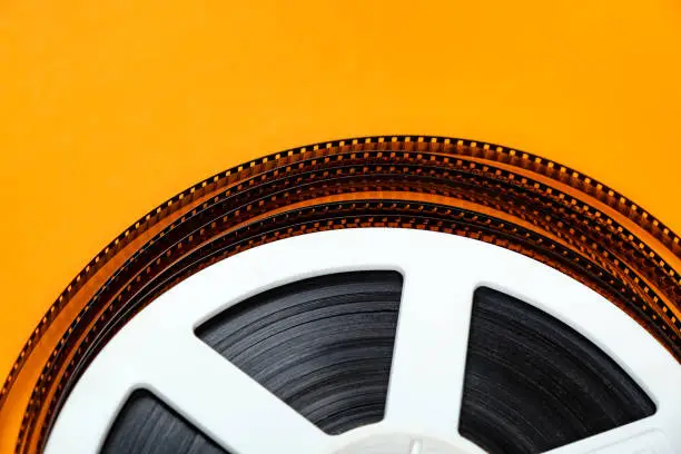 Old Film Reel on the Orange Background closeup