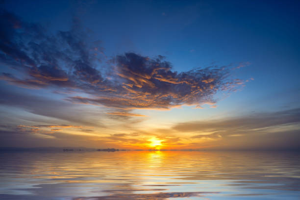 istock Sunset sky at the lake with clouds on the sky background. 1355230525