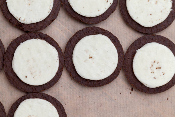 istock chocolate cookies with creamy cream filling 1355231824